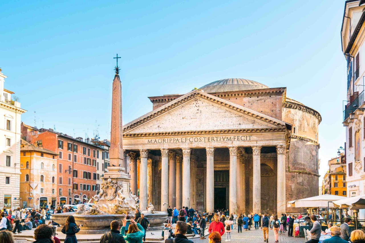 Rome, Italy - March 1, 2016: View of the Pantheon and the obelisk in Piazza della Rotonda in Rome, Italy. People can be seen walking around, exploring the area.